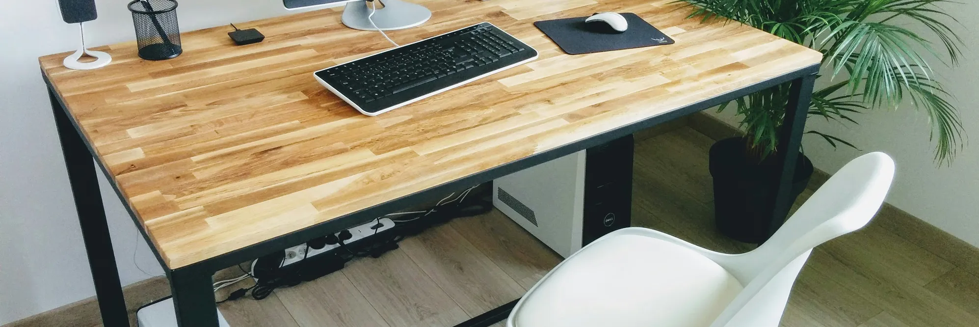 A computer desk with a keyboard and mouse.