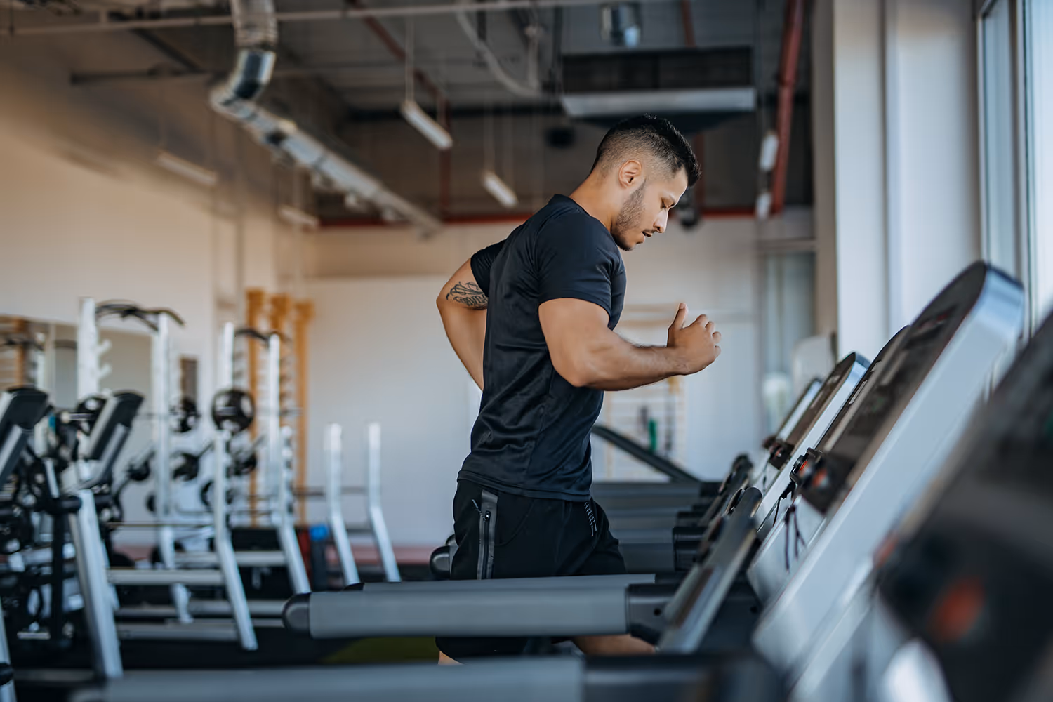 a man running on a treadmill in a gym
