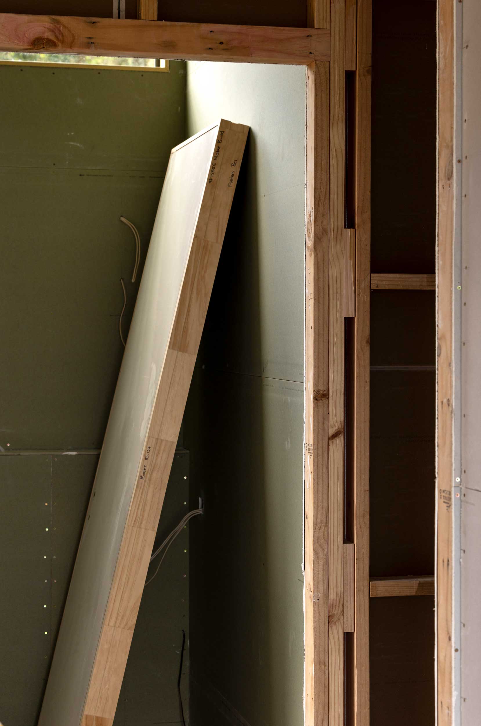 Interior door resting in the sun awaiting installation in Kinloch.