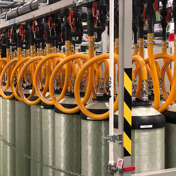 Rows of tanks with coiled orange hoses