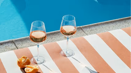 Wine glasses by a pool