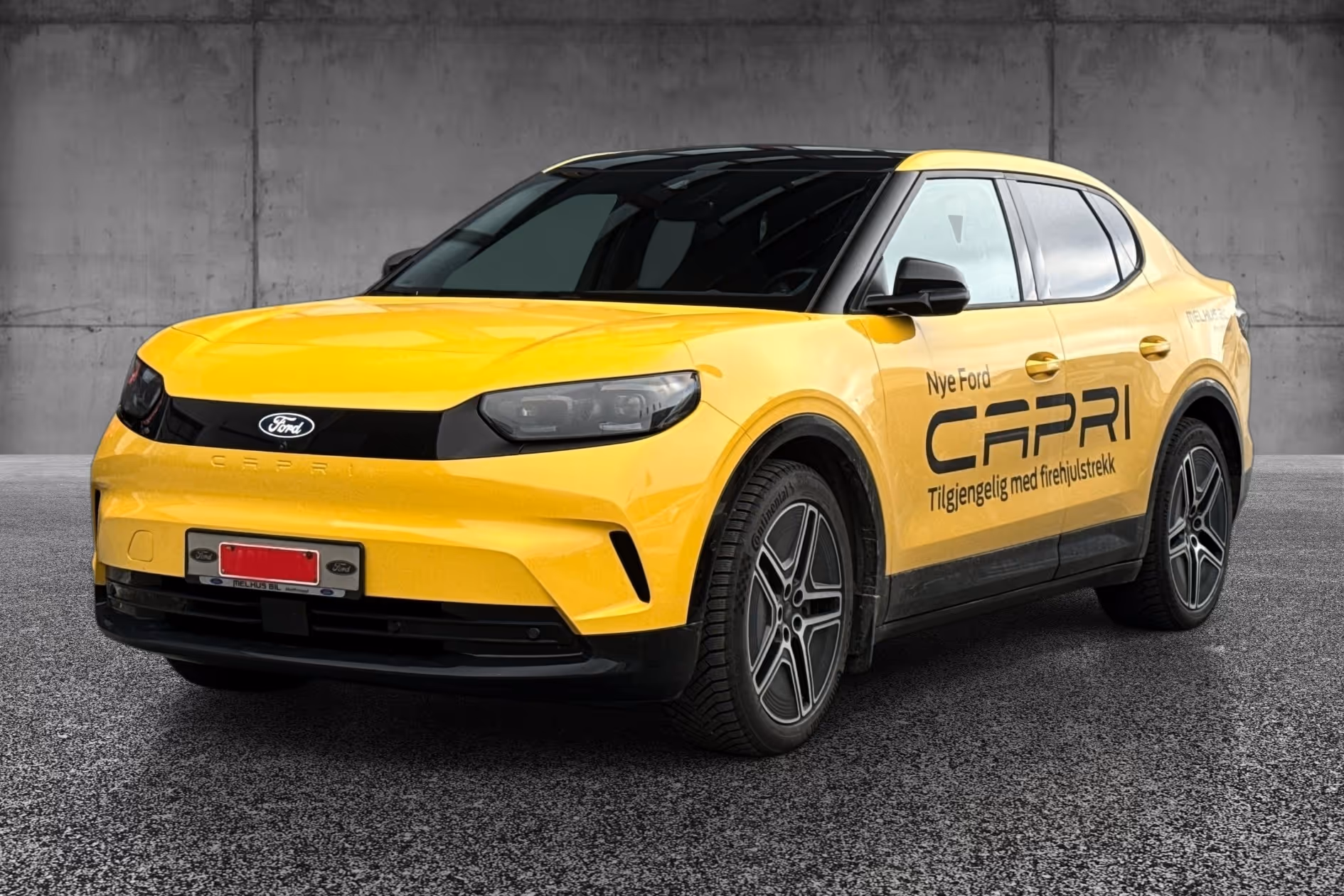 Yellow Ford Capri SUV with black roof parked on gray asphalt against a concrete wall.