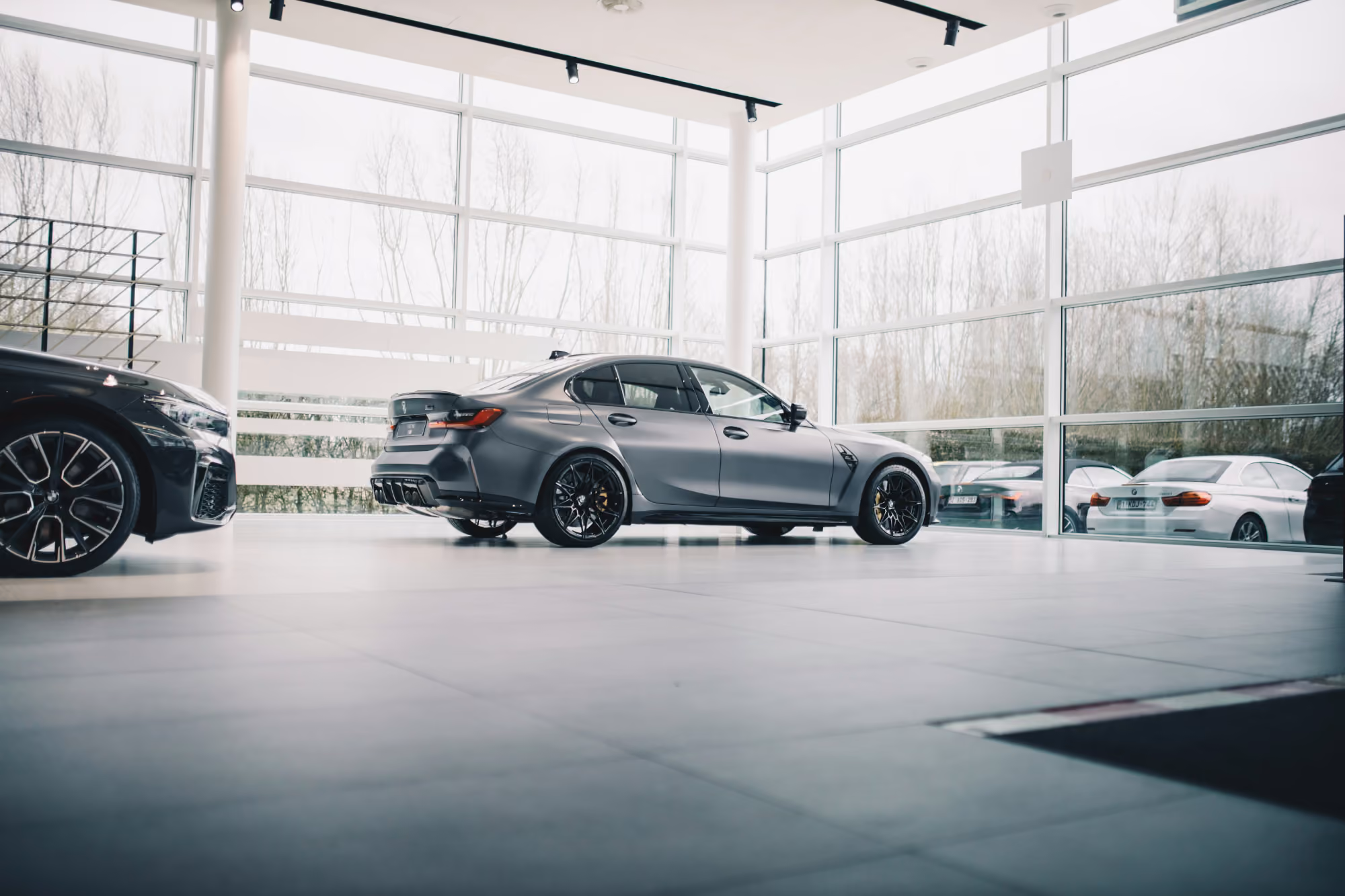 Gray sedan in dealership showroom