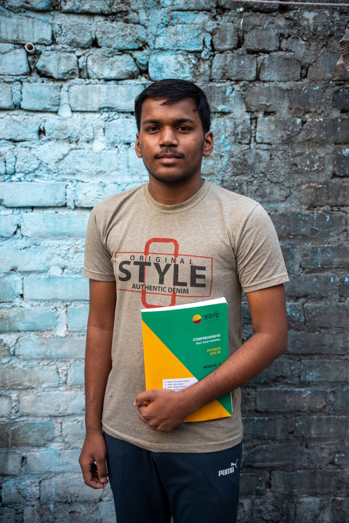 Portrait of Manish Gupta holding an Avanti Fellows Physics study module