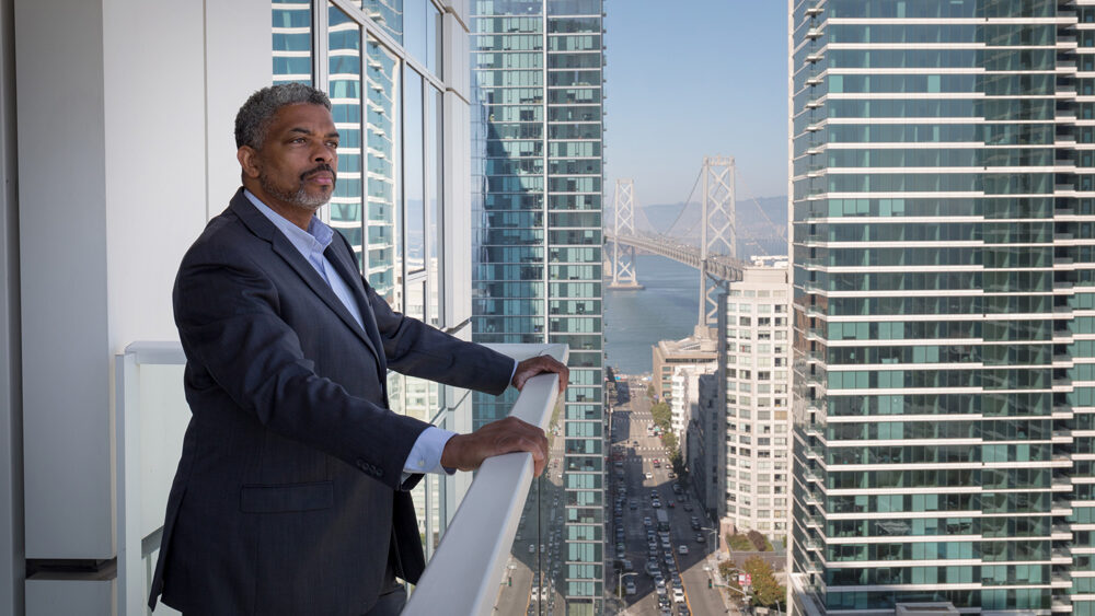 Man looking over the balcony at his Synergy apartment