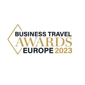 Logo for the Business Travel Awards Europe 2023, featuring gold and black text with a geometric design.