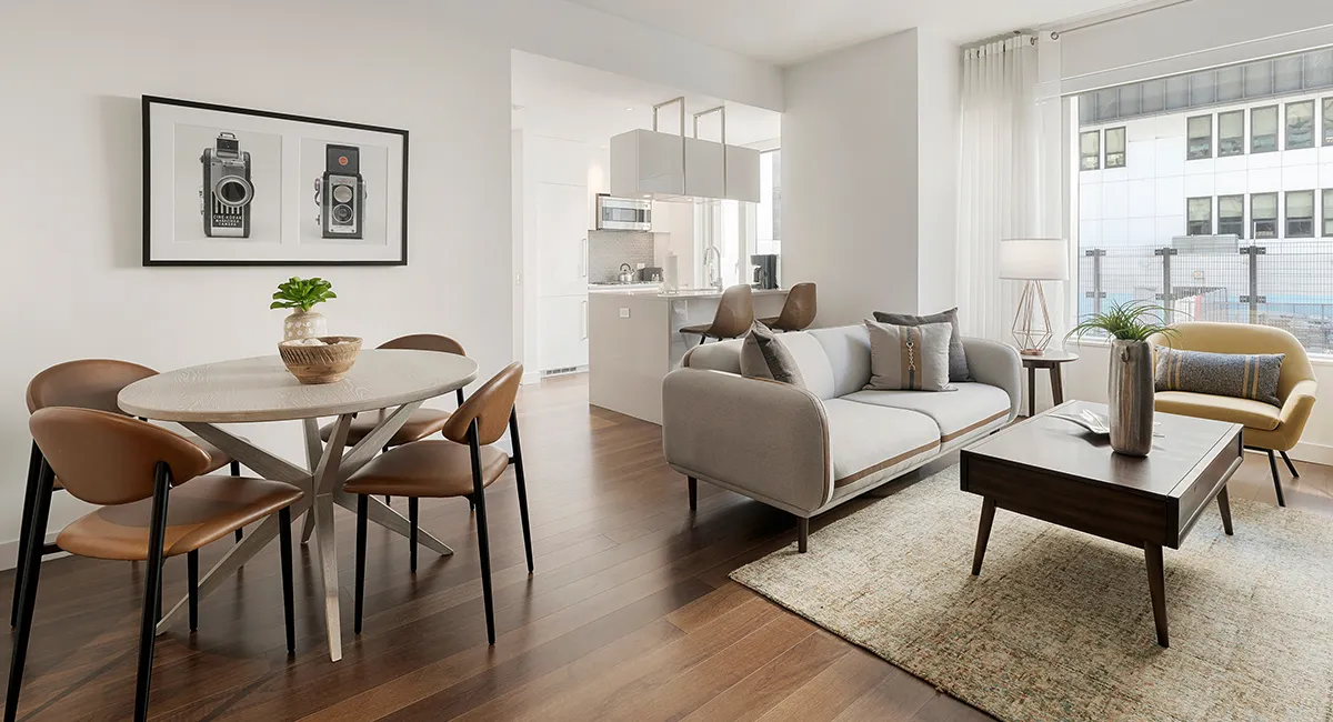 Modern open-concept living and dining area with sleek furniture and natural light.