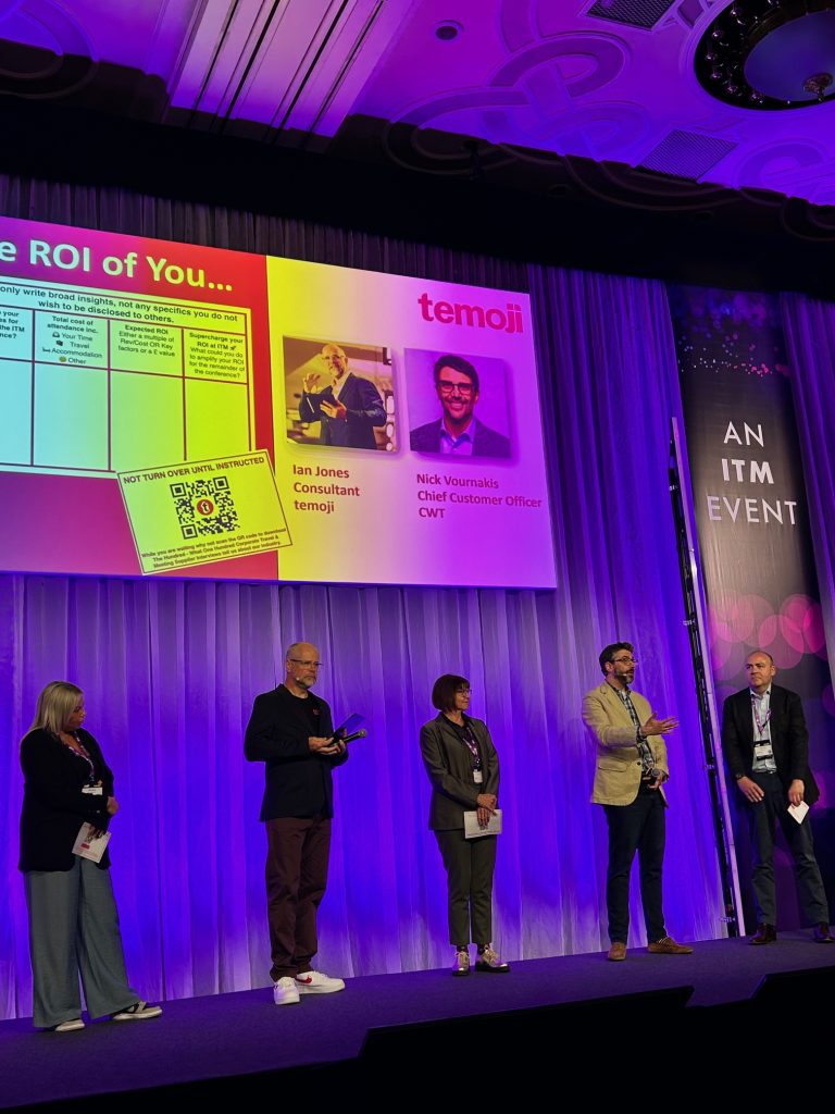 A professional event features speakers on stage with a presentation about ROI and branding.