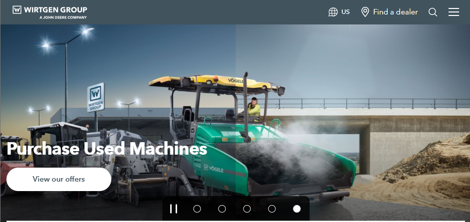 Wirtgen Group homepage banner showing a Vögele road paver in operation on a construction site near an overpass, with the headline “Purchase Used Machines,” a “View our offers” button, and navigation elements including region selection and dealer locator.