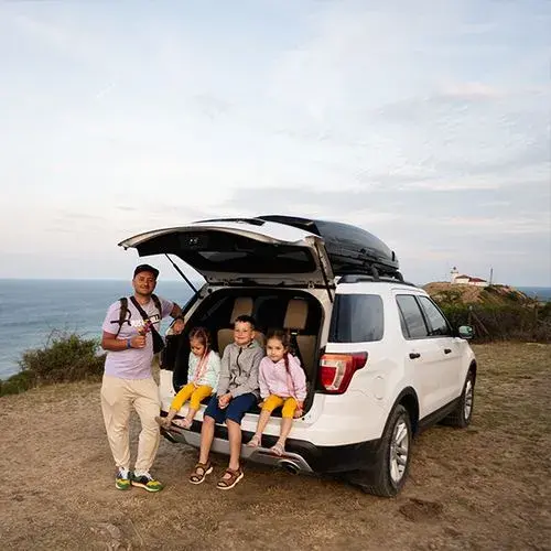 A group of people sitting in the back of a van.