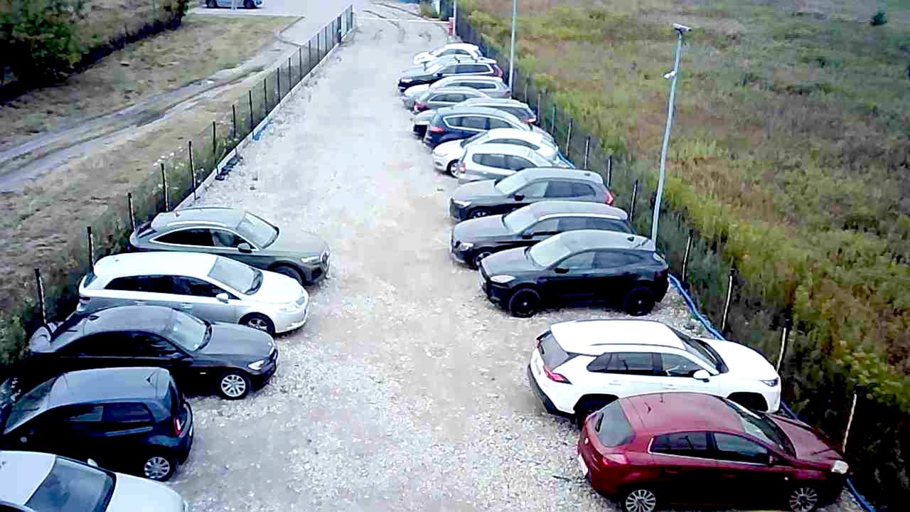 A parking lot filled with lots of parked cars.