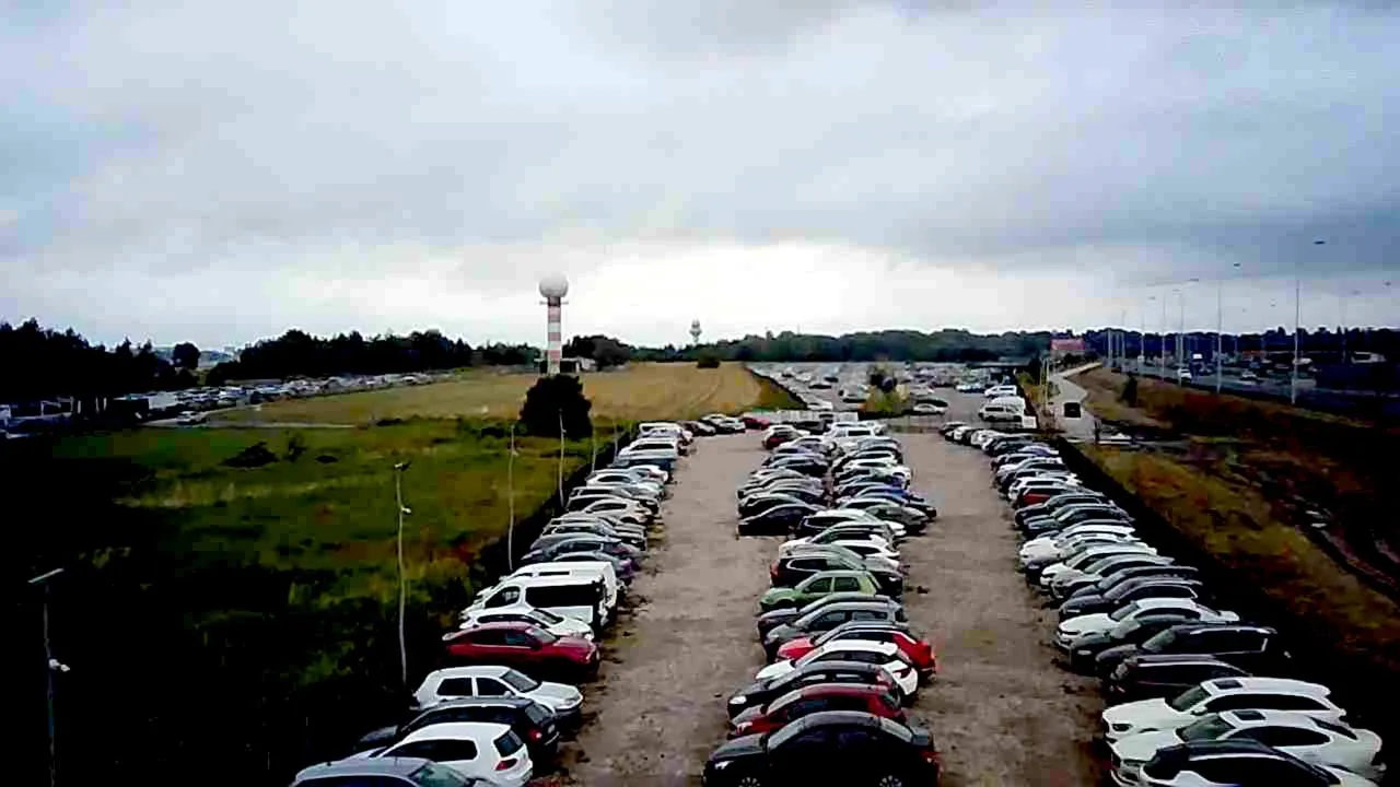 A parking lot filled with lots of parked cars.