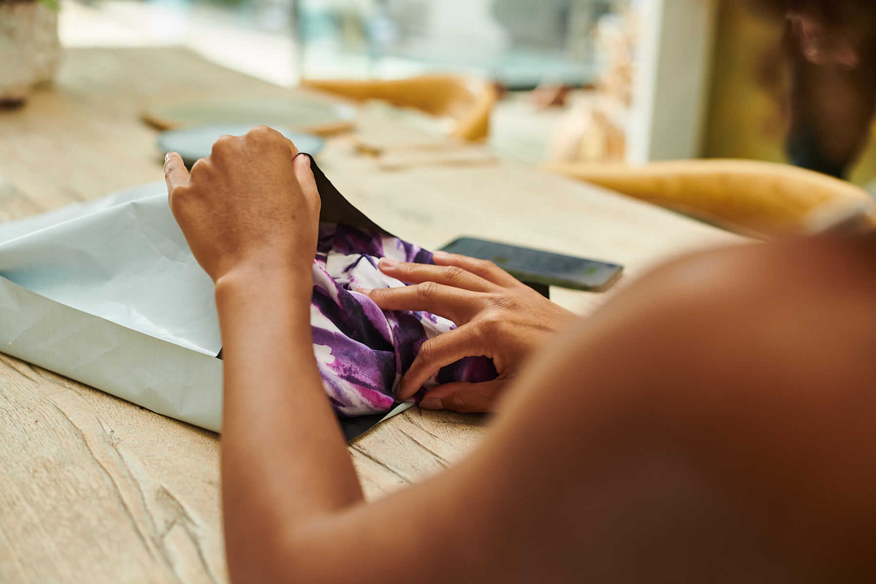 A shopper ppackages their dresses up for return, collected by Relay