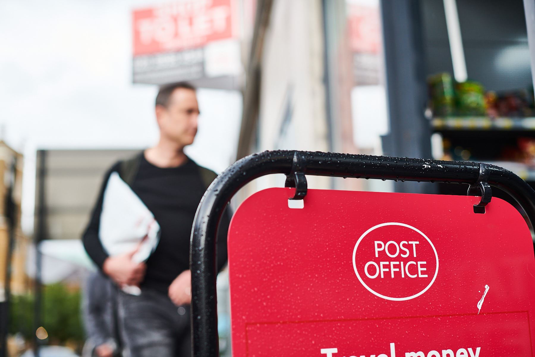 A shopper processing their return at a Post Office