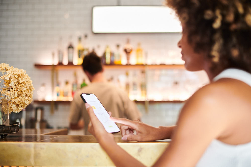 Customer returning via WhatsApp in a bar