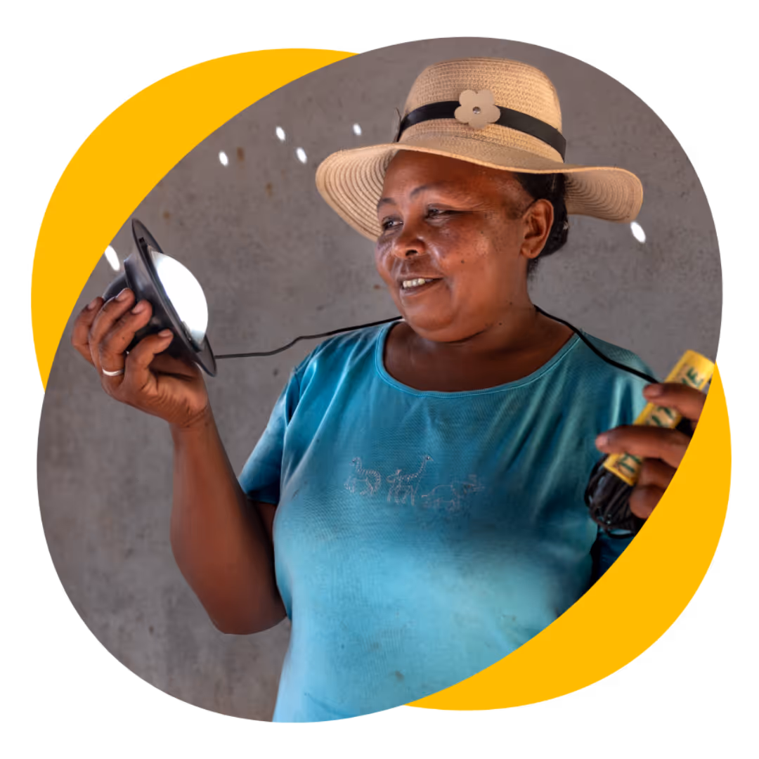 A woman holding a light powered by solar batteries.