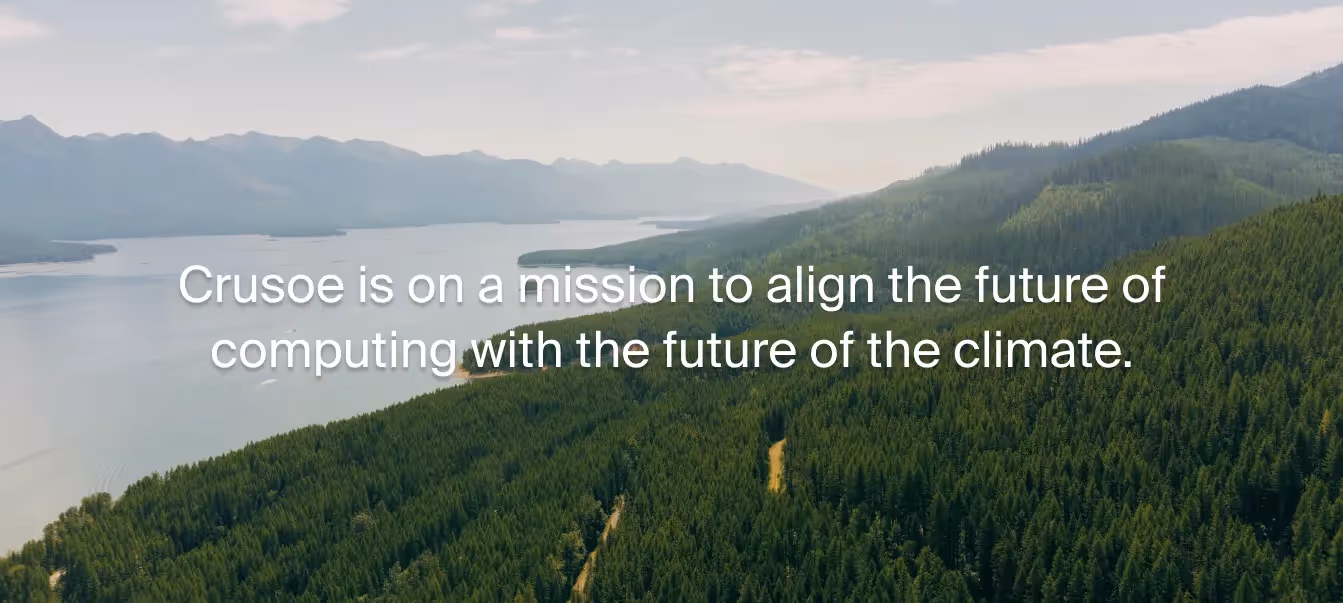 Aerial view of dense evergreen forest beside a calm lakelaid with the text: ‘Crusoe is on a mission to align the future of computing with the future of climate.