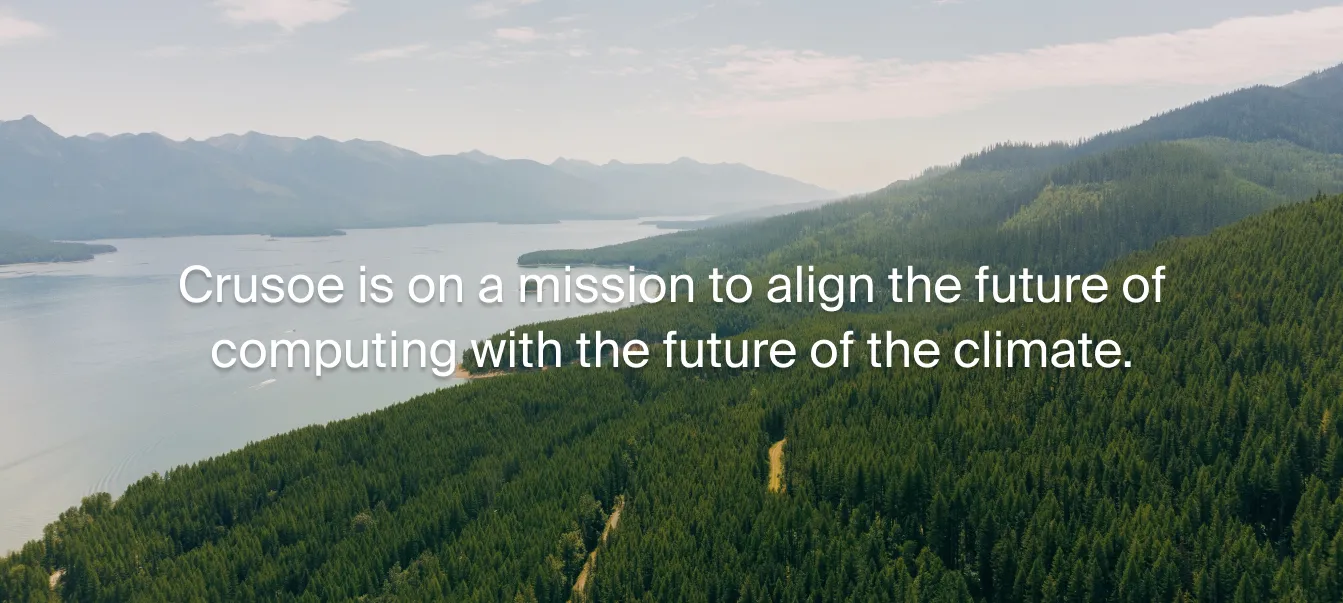 Aerial view of dense evergreen forest beside a calm lakelaid with the text: ‘Crusoe is on a mission to align the future of computing with the future of climate.