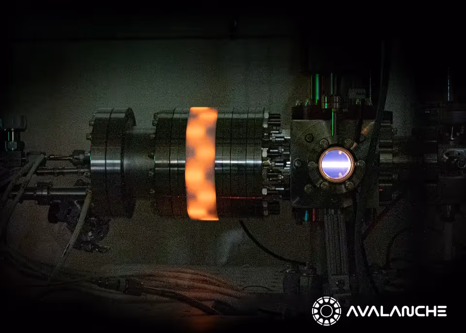 Bright orange plasma glowing inside a cylindrical energy reactor at Avalanche’s facility.