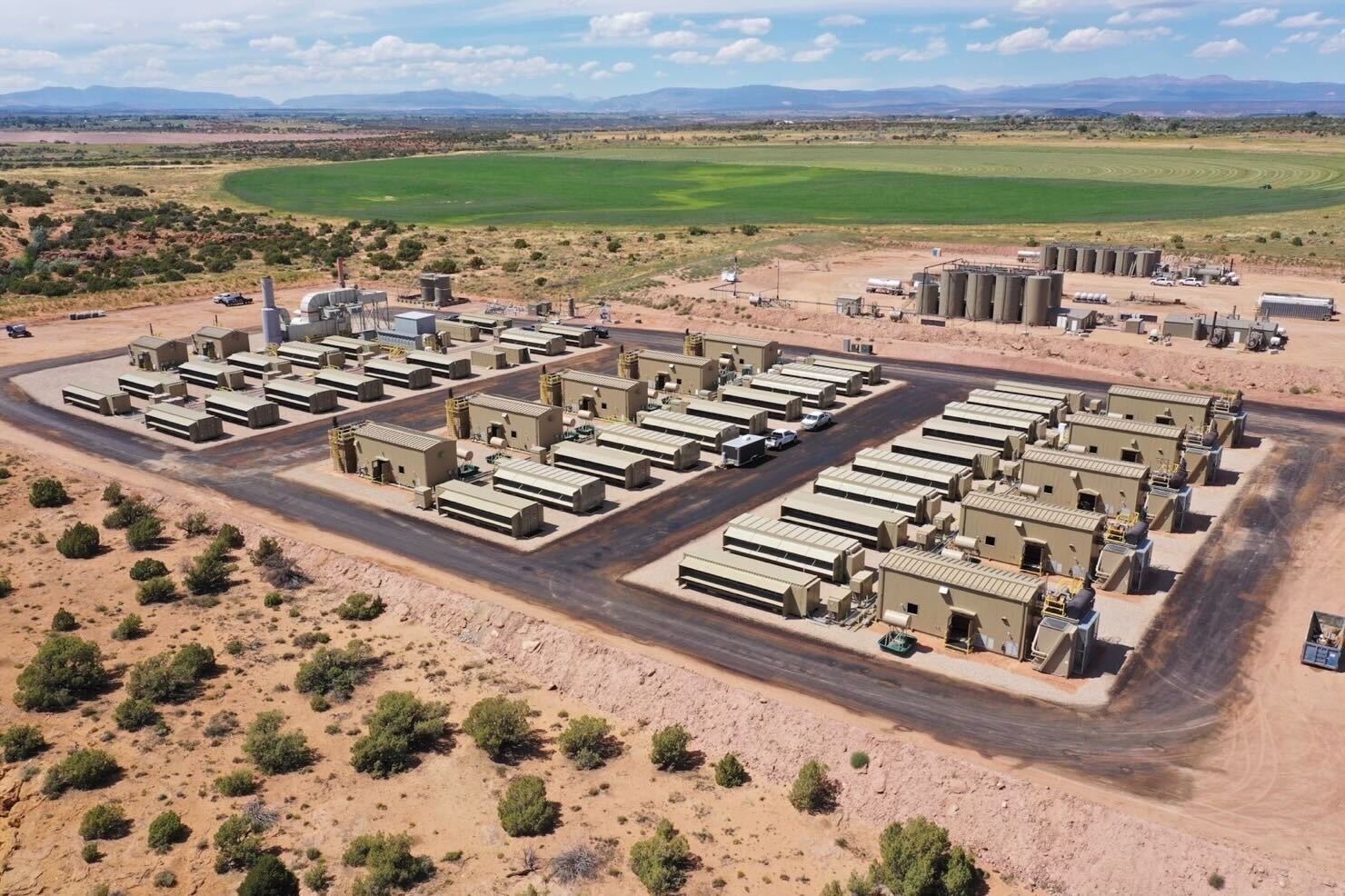 An aerial view of a large-scale data center in a rural landscape.