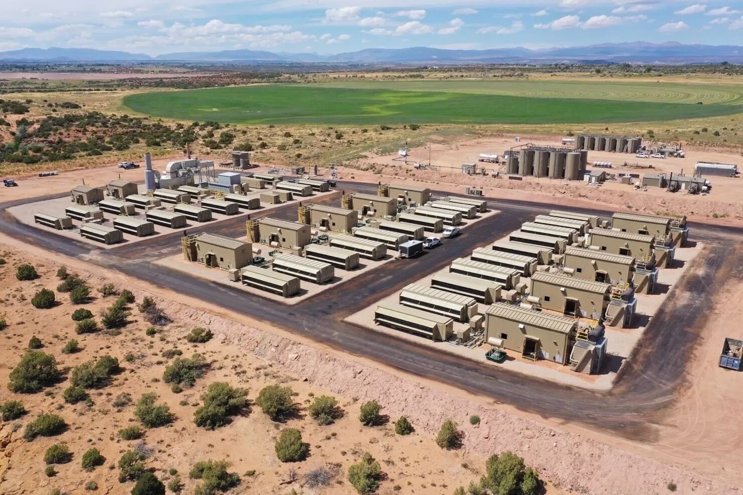 An aerial view of a large-scale data center in a rural landscape.