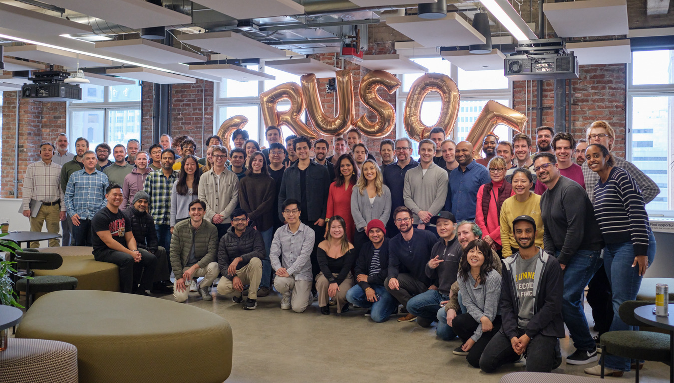 Group photo of the Crusoe team gathered in their office.