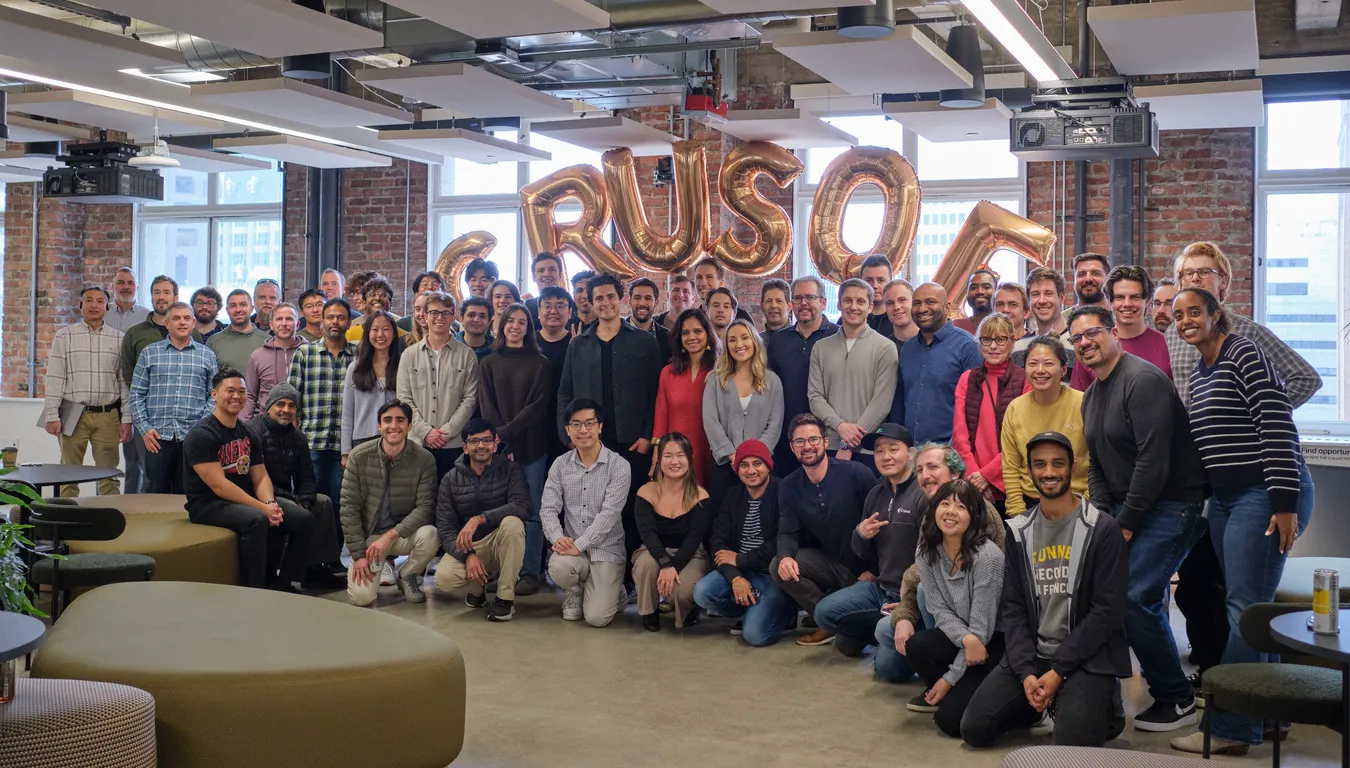 Group photo of the Crusoe team gathered in their office.