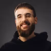 Professional headshot of Oliver Cameron (CEO of Odyssey) wearing glasses and a black hoodie.