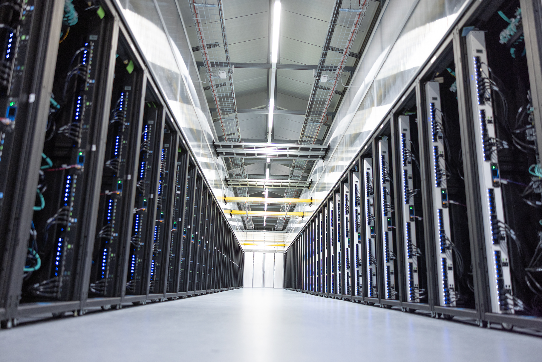 Photograph of data center hallway showcasing GPUs.