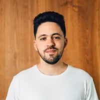 Headshot of Roey Lalazar against wooden background