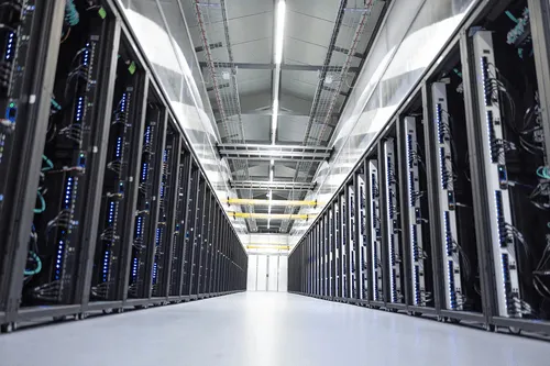Photograph of data center hallway showcasing GPUs.
