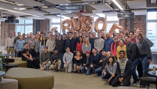 Group photo of the Crusoe team gathered in their office.