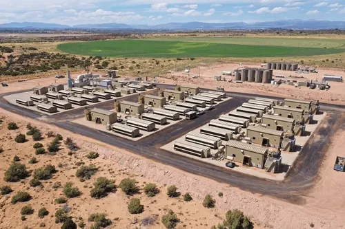 An aerial view of a large-scale data center in a rural landscape.