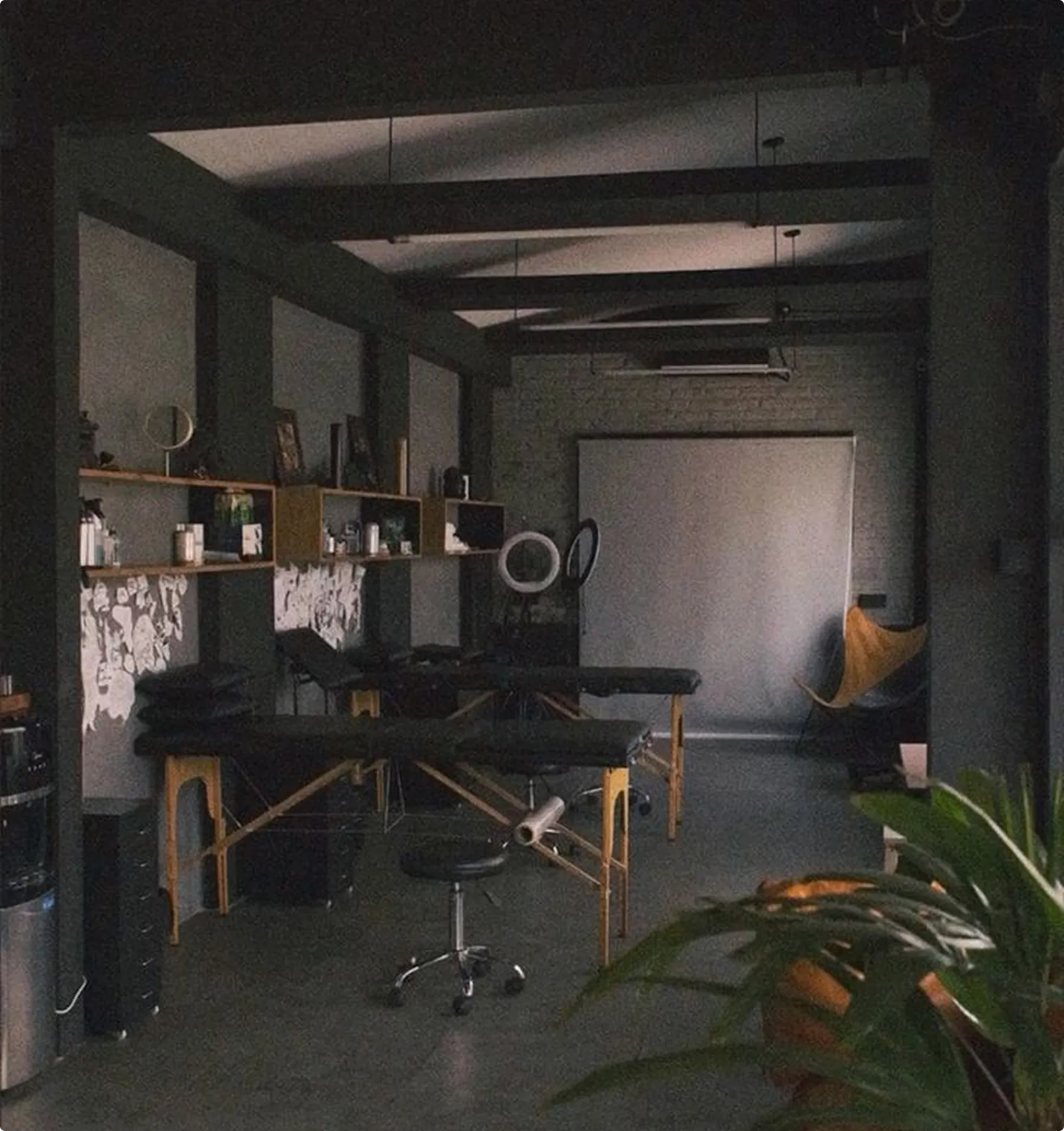 A tattoo artist's studio setup, with tattooing equipment, beds, and a calm, minimalistic environment.