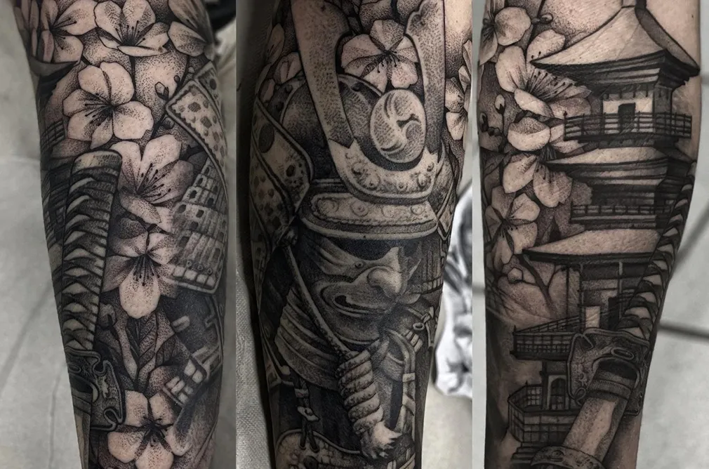Tattoo of a traditional Japanese warrior with intricate floral details, blending culture and history into a beautiful sleeve design.