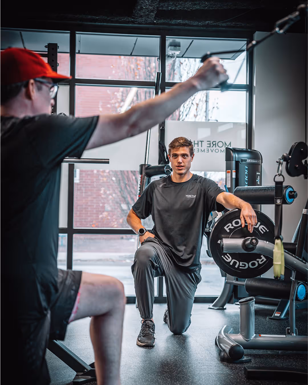 Physical therapist performing strength assessment for shoulder injury at More Than Movement in Philadelphia