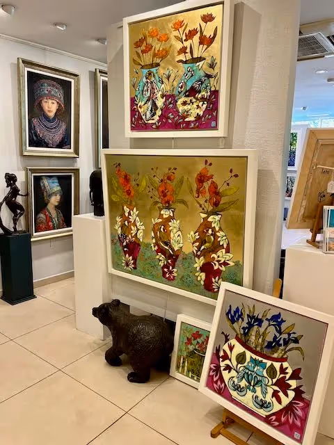 Interior of No Naked Walls Gallery with paintings and print artwork