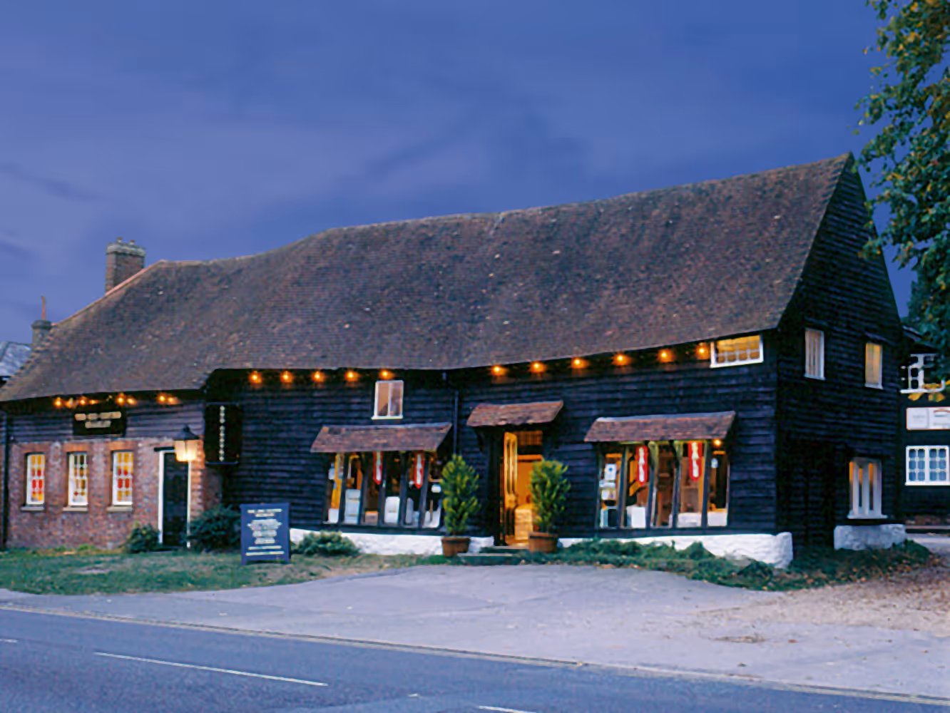 Bramley Bed Centre store at night, lit up.