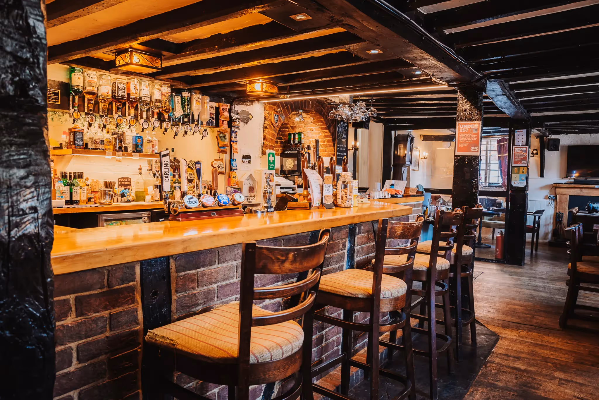 Interior of a village pub bar with wooden framing