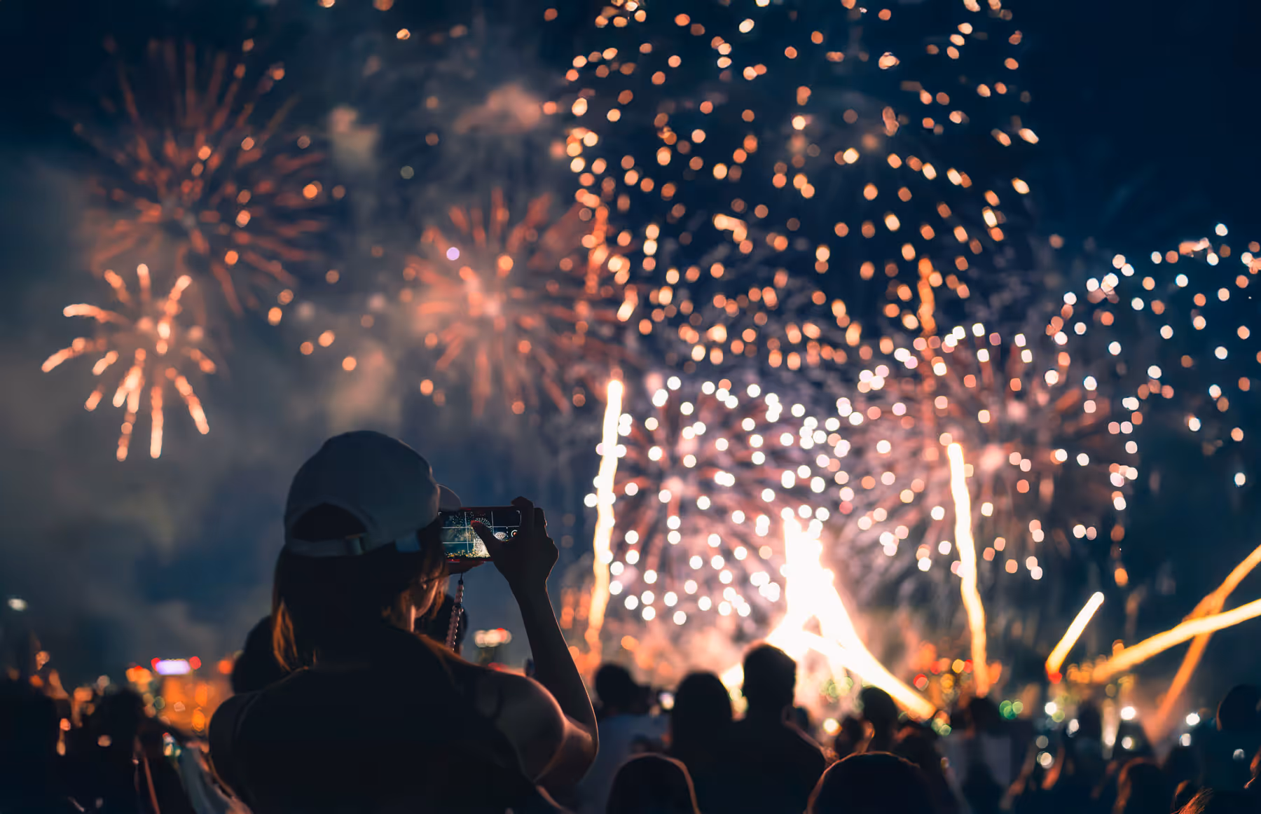 People gathering to watch a spectacular colourful fireworks display