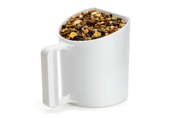 Feed scoop filled to the brim with a granola or mixed cereal blend.