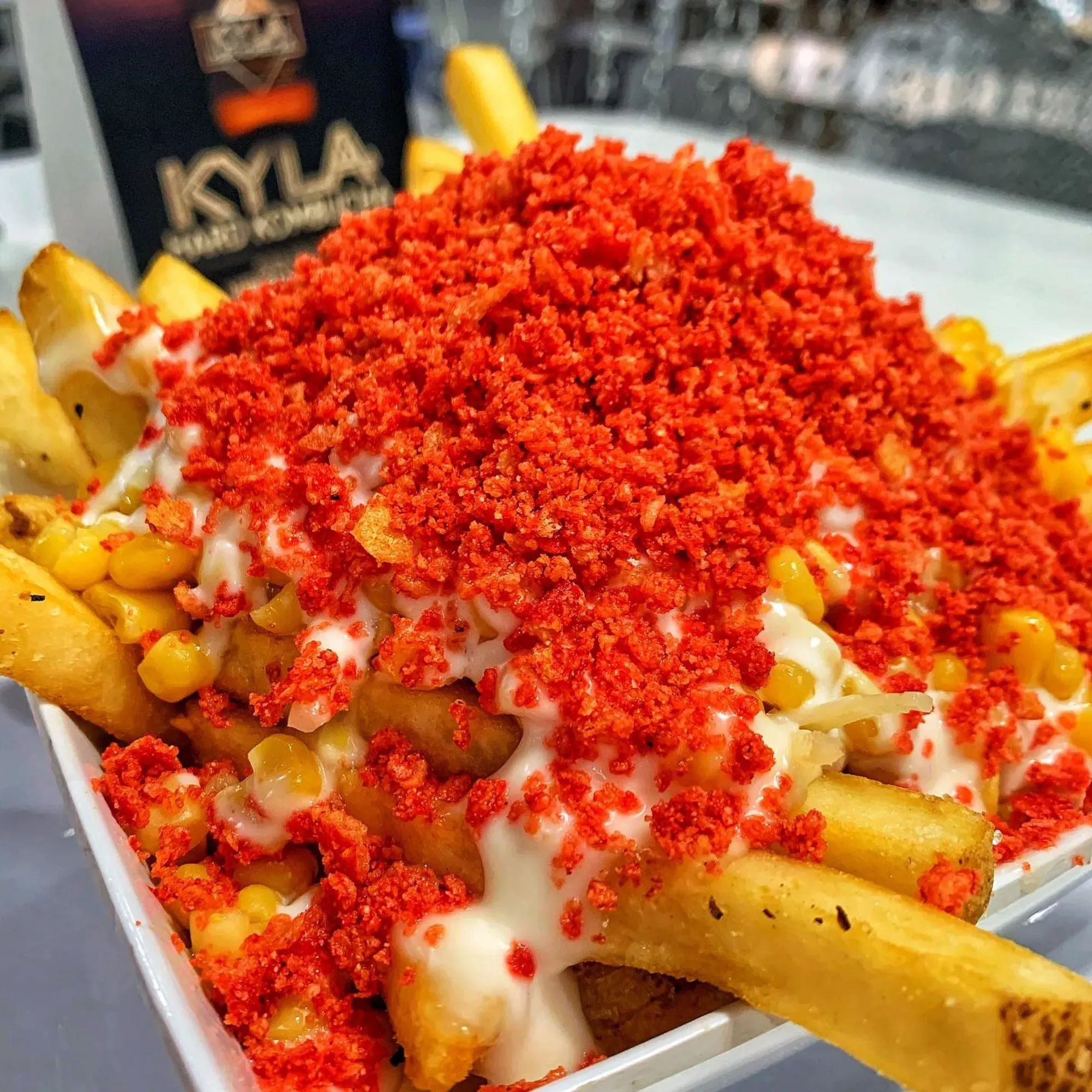 A bowl of french fries covered in red seasoning.