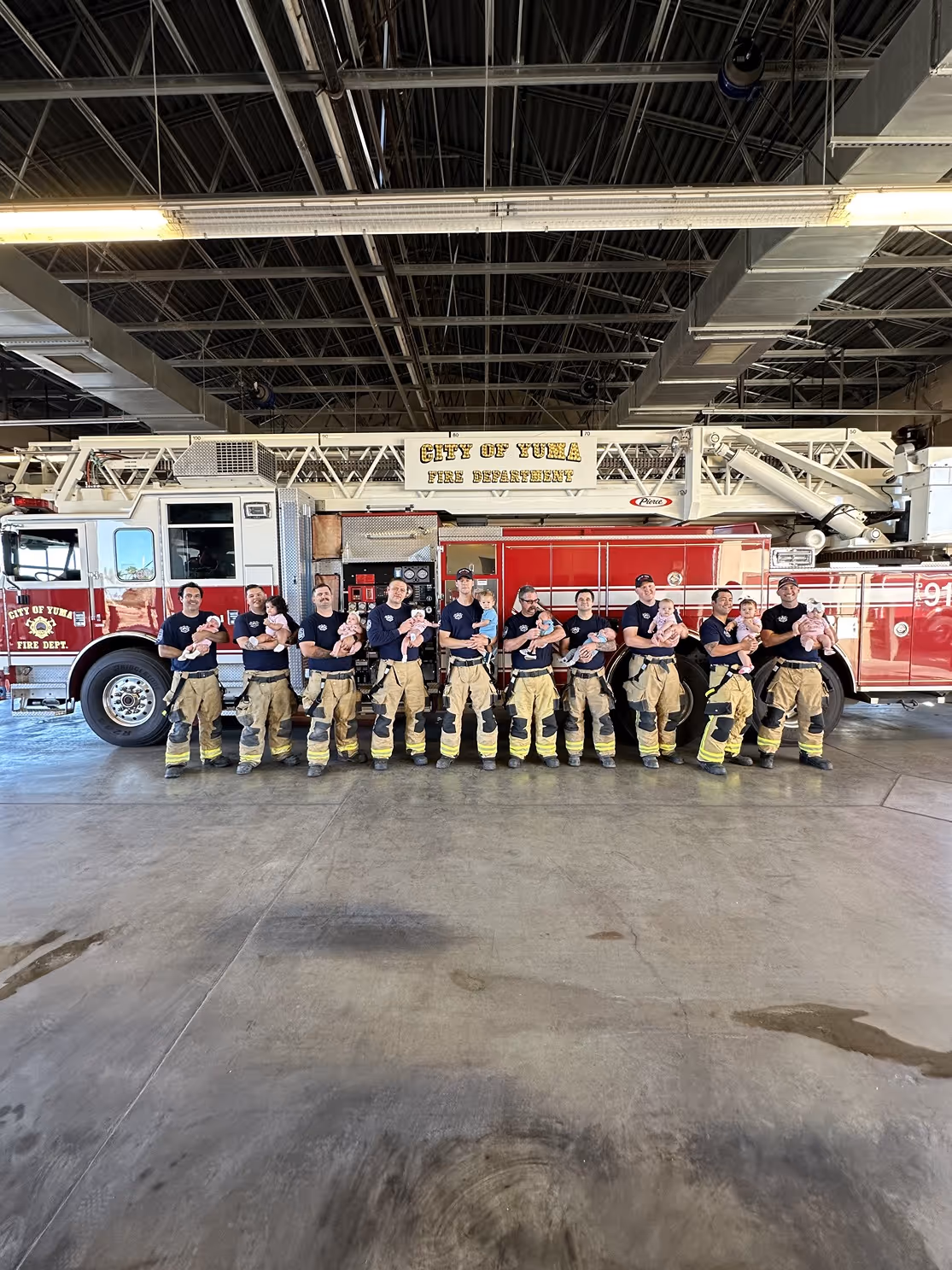 Group photo of United Yuma Firefighters in uniform in front of fire truck