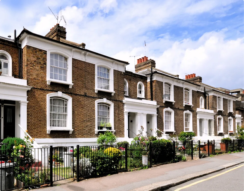 Asthetically pleasing row of London victorian houses with nice brickwork white pillared doorways and sash windows.