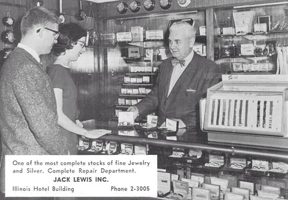 Black and white photo of original owner Jack Lewis behind the counter selling jewelry to a young couple in the 1930s