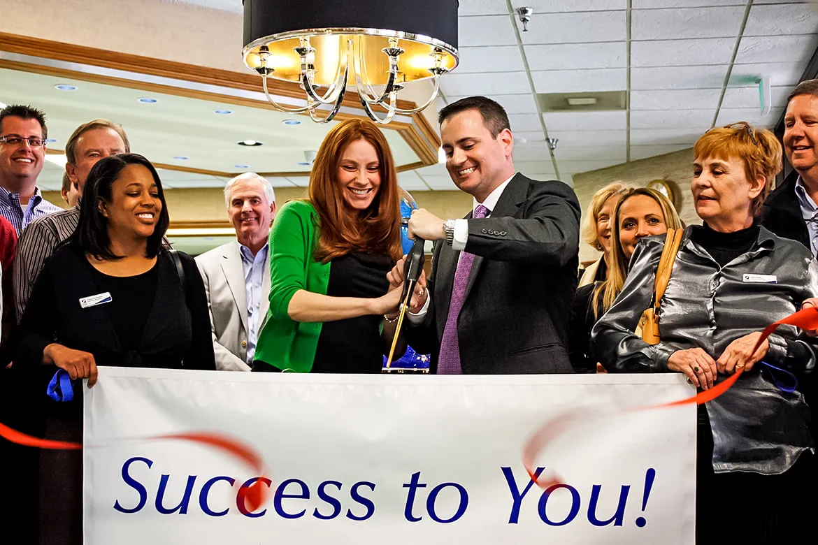 CEO John Carter and his wife Ketty cutting the ribbon with the McLean County Chamber in 2011