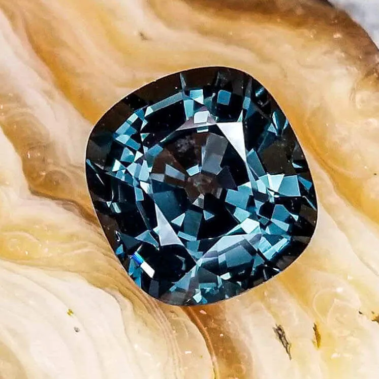 square shaped teal spinel gemstone with rounded edges
