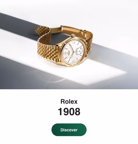 Positioned to the left against a luminous backdrop of soft gradients and shadow, the Rolex Perpetual 1908 in 18 ct yellow gold features a 39 mm case, elegant white dial, and finely fluted bezel. Its transparent case back reveals the calibre 7140, a self-winding mechanical movement with a Syloxi hairspring. Paired with a polished yellow gold Jubilee bracelet, this timepiece embodies refinement and modern precision. Jack Lewis Jewelers of Bloomington, Illinois, now at 3011 Galena Rd, is proud to be part of the worldwide network of Official Rolex Jewelers.