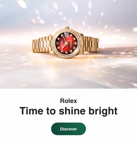 Positioned to the left against a luminous, shimmering backdrop, the Rolex Datejust in yellow gold features a striking red dial illuminated by diamond hour markers. Its elegant profile is enhanced by a diamond-set bezel and the iconic President bracelet, reflecting light in a cascade of warm gold tones. Equipped with the signature date display at 3 o’clock and crafted for precision, reliability, and enduring style, this Datejust embodies timeless luxury. Jack Lewis Jewelers of Bloomington, Illinois, now at 3011 Galena Rd, is proud to be part of the worldwide network of Official Rolex Jewelers.