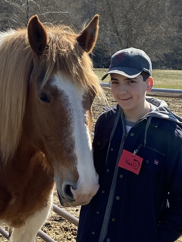 Noah with a horse at Equine-Assisted Therapy